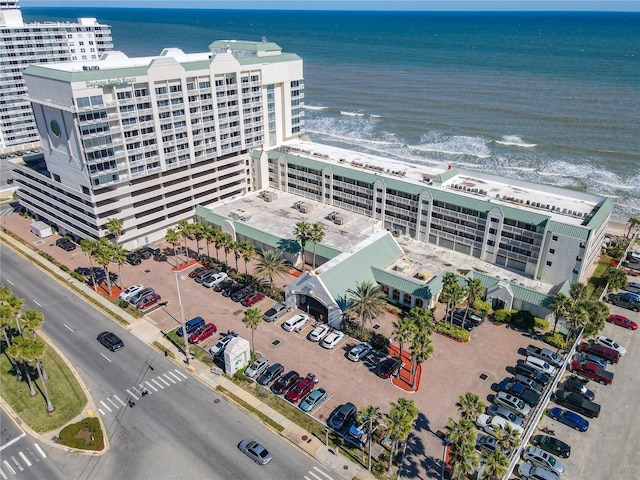 drone / aerial view featuring a water view and a view of the beach