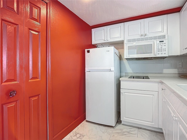 kitchen featuring white cabinetry, white appliances, and decorative backsplash