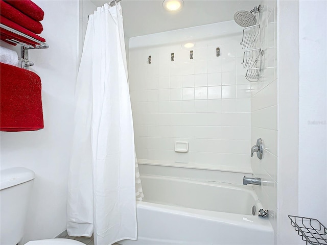 bathroom featuring shower / bath combo and toilet