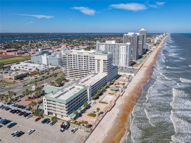 bird's eye view with a water view and a beach view