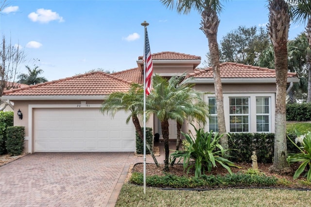 mediterranean / spanish-style home with a garage