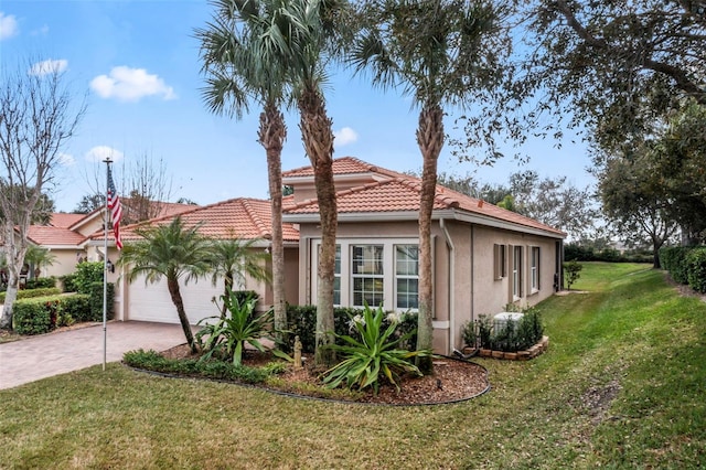 view of front facade with a garage and a front lawn