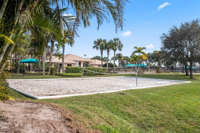 view of property's community with a lawn and volleyball court