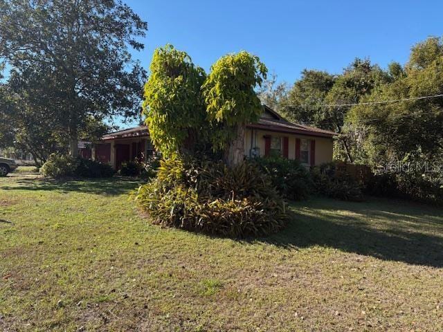 view of property exterior with a yard