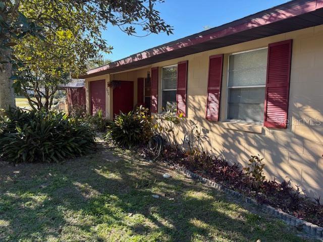 view of side of property with a lawn