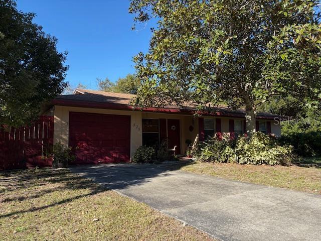 ranch-style home with a garage and a front yard