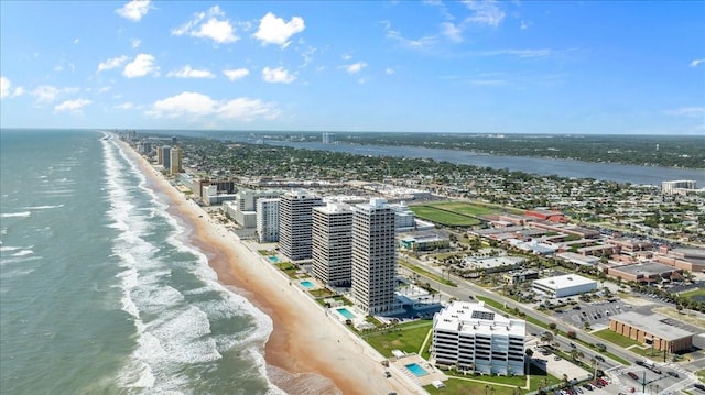 birds eye view of property with a water view and a view of the beach