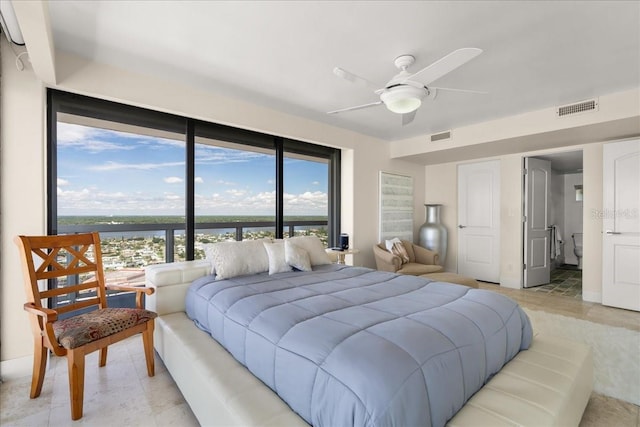 bedroom with light tile patterned flooring, a water view, and ceiling fan