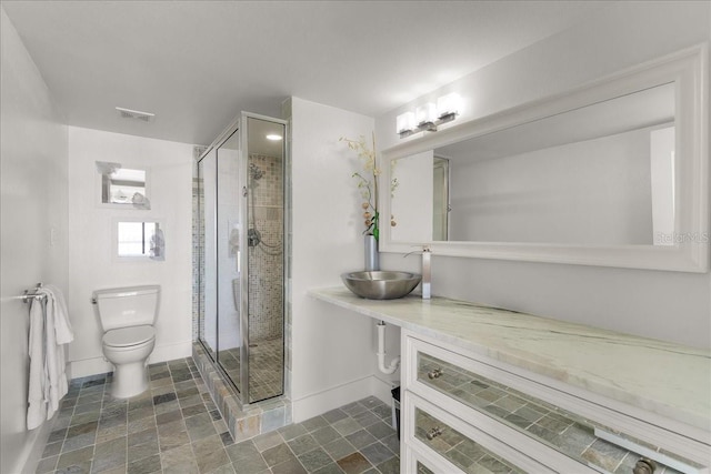 bathroom with vanity, toilet, and walk in shower