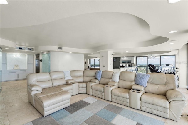 living room with lofted ceiling and light tile patterned floors