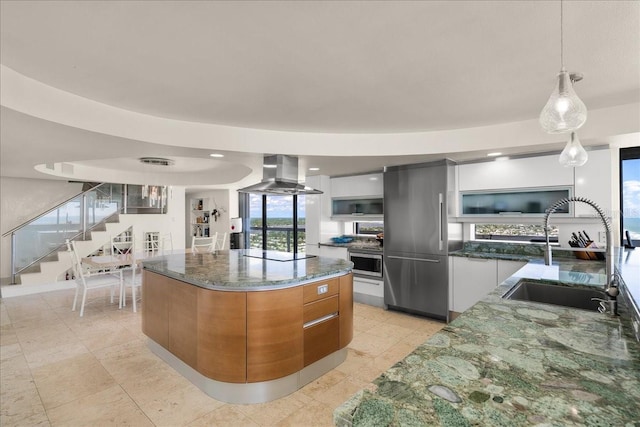 kitchen featuring a large island, ventilation hood, sink, and white cabinets