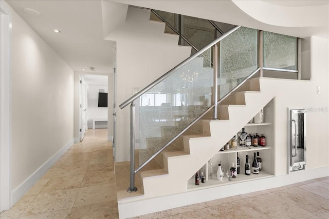 staircase featuring built in shelves and tile patterned floors