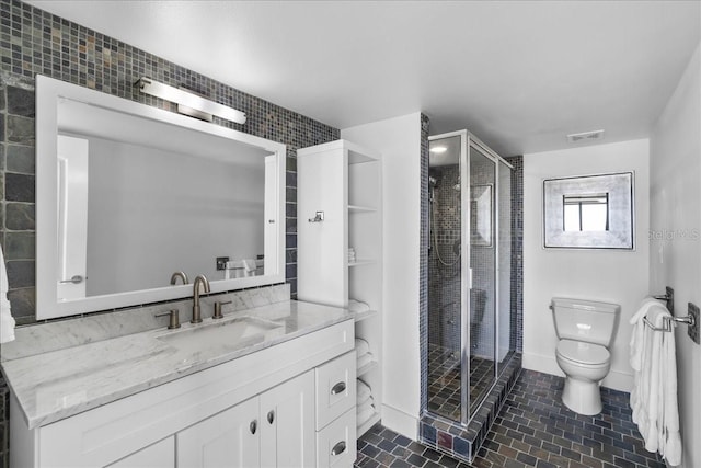 bathroom with vanity, toilet, and a shower with shower door