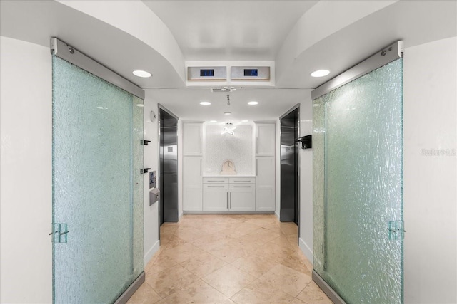 hallway featuring light tile patterned flooring