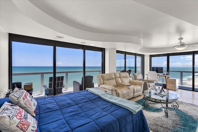 bedroom featuring access to outside and a wall of windows