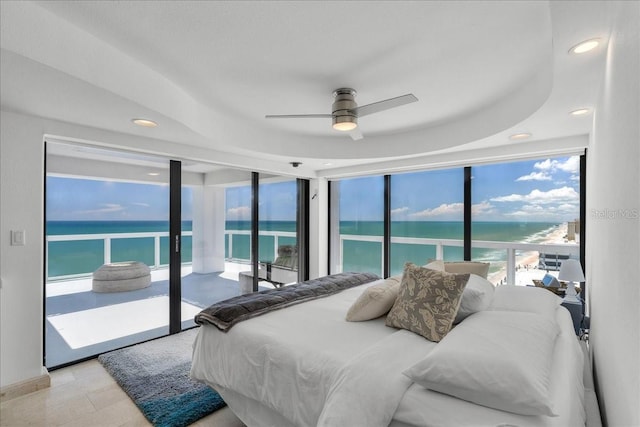 bedroom featuring multiple windows, a water view, and ceiling fan