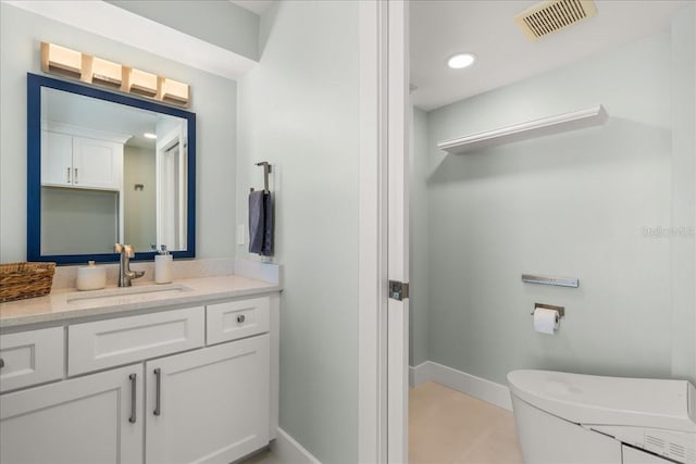 bathroom featuring vanity and toilet