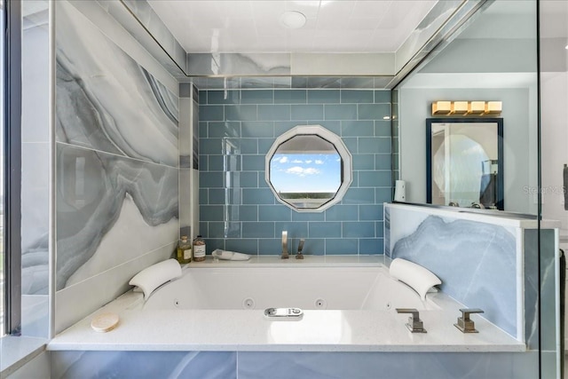 bathroom featuring a bath and tile walls