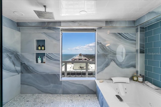 bathroom featuring tile walls and a tub to relax in