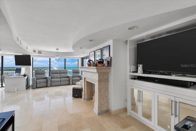 living room with expansive windows and a high end fireplace