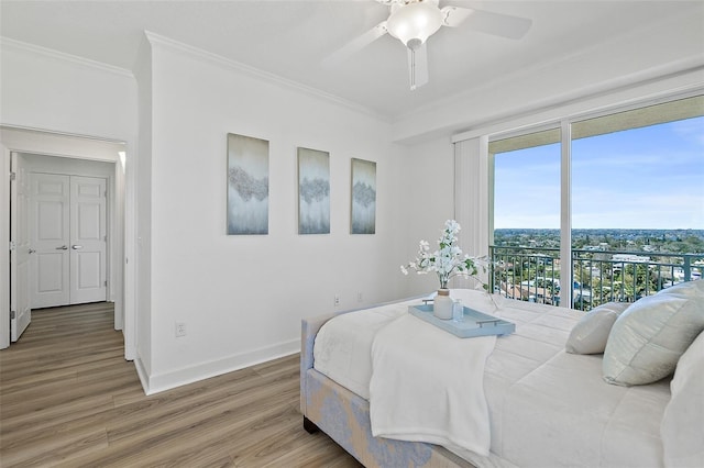 bedroom featuring ornamental molding, hardwood / wood-style floors, and ceiling fan