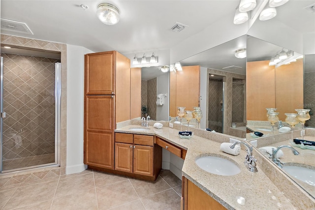 bathroom with tile patterned flooring, vanity, and walk in shower