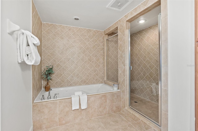 bathroom featuring tile patterned floors and independent shower and bath