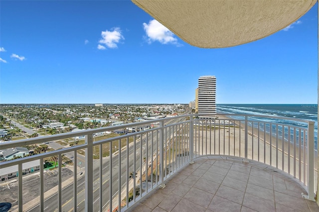 balcony featuring a water view and a view of the beach