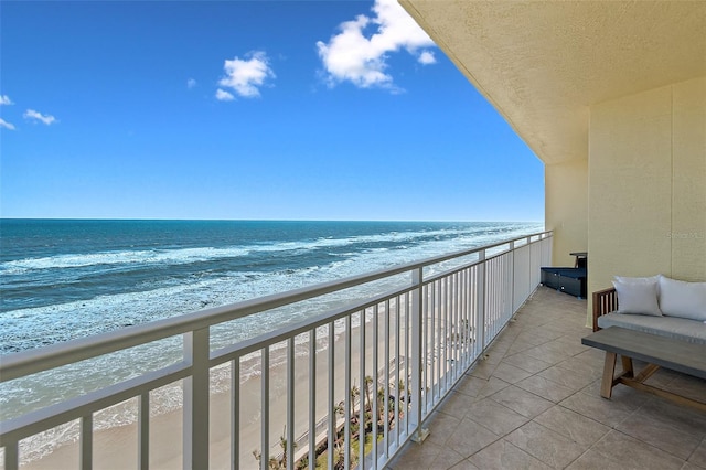 balcony with a beach view and a water view