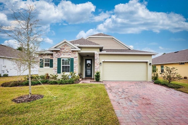 view of front of house with a garage and a front lawn