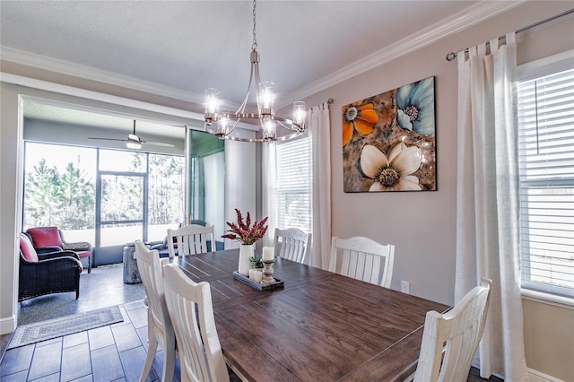 tiled dining space with ceiling fan with notable chandelier and crown molding