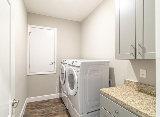 laundry room with independent washer and dryer, cabinets, and dark hardwood / wood-style flooring