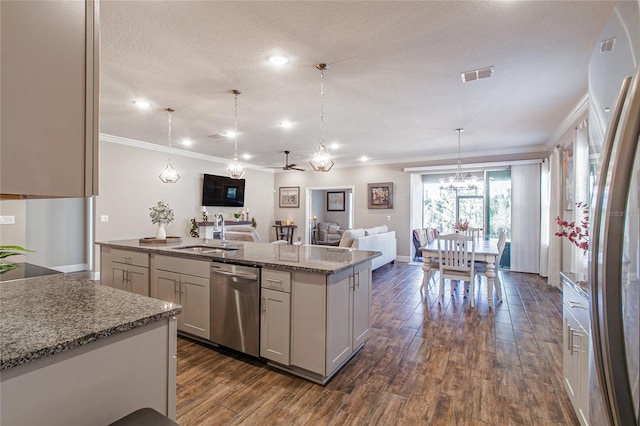 kitchen featuring an island with sink, sink, light stone counters, dishwasher, and pendant lighting