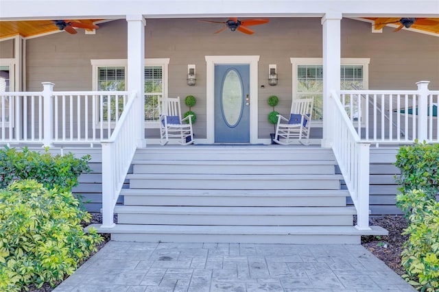 entrance to property featuring a porch and ceiling fan