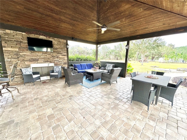 view of patio with outdoor lounge area, a gazebo, outdoor dining space, and a ceiling fan