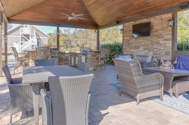 view of patio / terrace featuring area for grilling, outdoor dining space, a ceiling fan, stairway, and grilling area