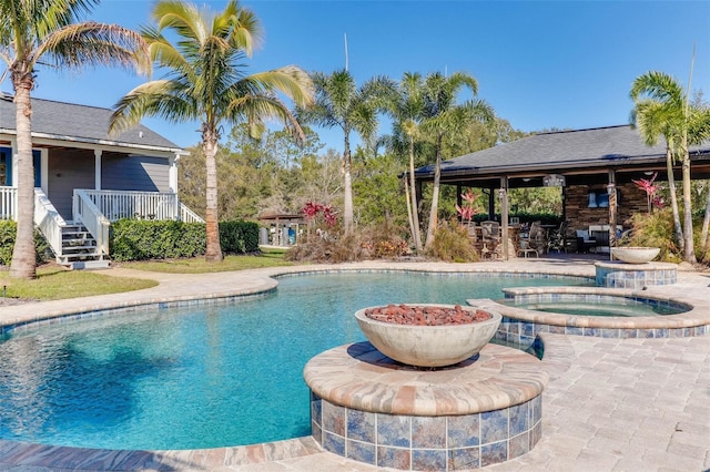 view of swimming pool featuring a patio area and a pool with connected hot tub