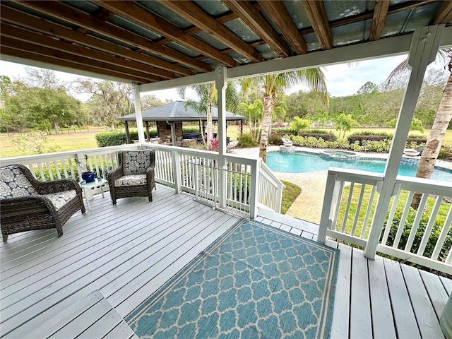 deck featuring a gazebo and a pool with connected hot tub