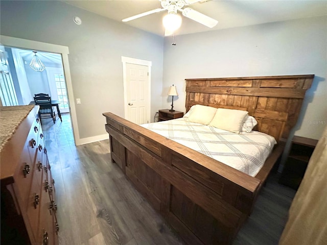 bedroom featuring baseboards, dark wood-style floors, and a ceiling fan