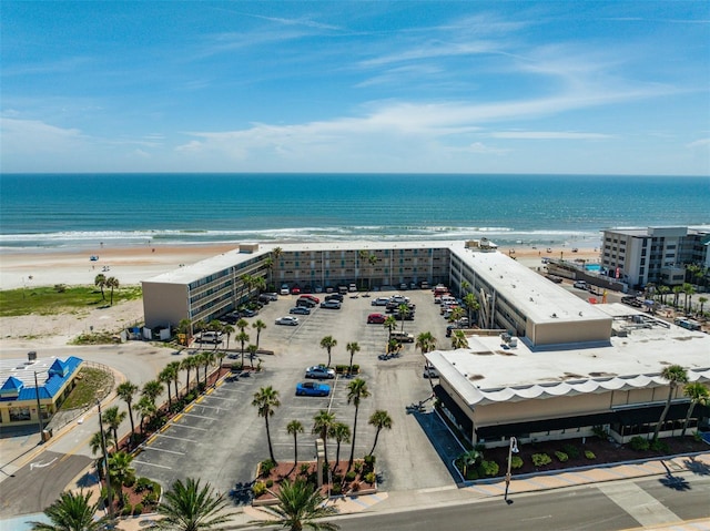 drone / aerial view featuring a beach view and a water view