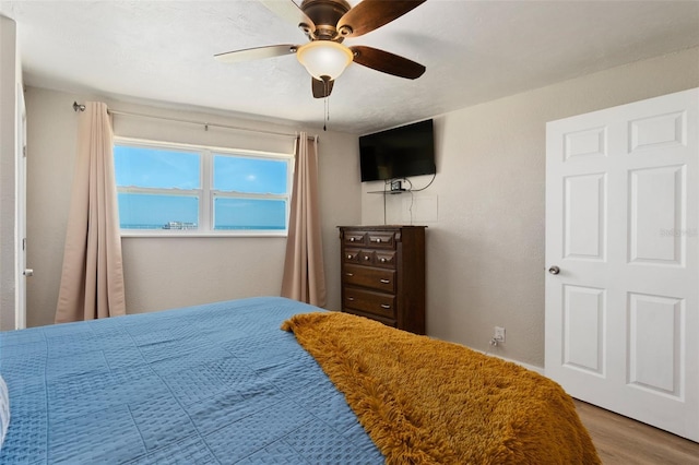 bedroom with hardwood / wood-style flooring and ceiling fan