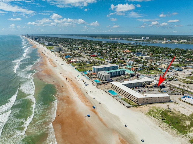 bird's eye view featuring a water view and a beach view