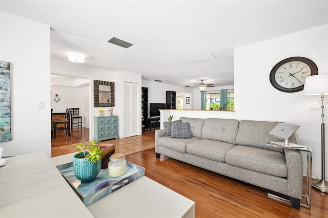 living room featuring ceiling fan and wood-type flooring