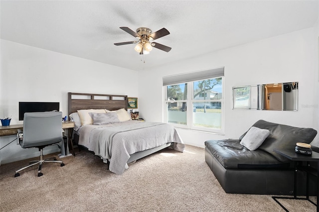 bedroom featuring carpet, a textured ceiling, and ceiling fan