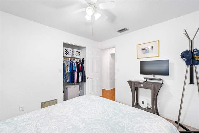 bedroom with ceiling fan and a closet