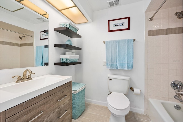 full bathroom featuring vanity, tiled shower / bath, hardwood / wood-style floors, and toilet