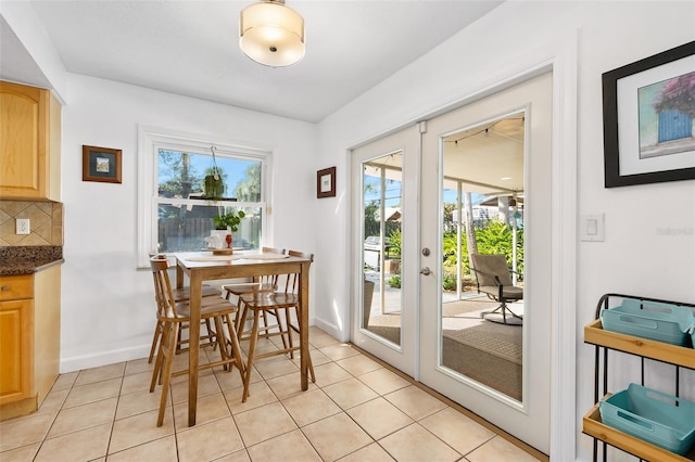 dining room featuring light tile patterned floors and french doors