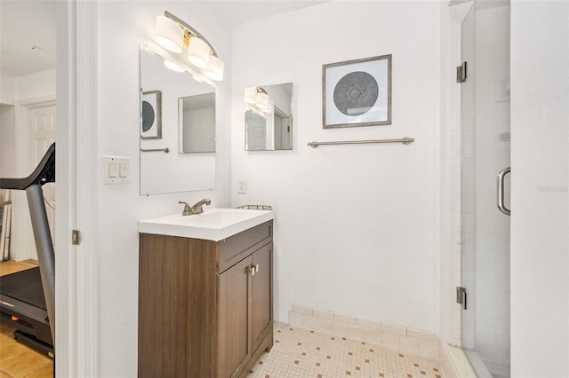 bathroom with vanity and a shower with door