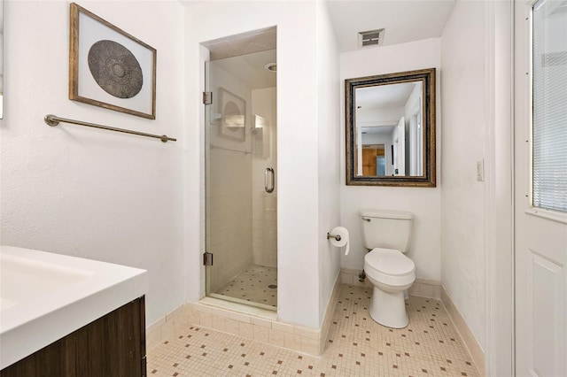 bathroom with tile patterned flooring, vanity, an enclosed shower, and toilet