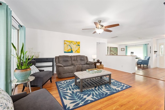 living room with ceiling fan and light hardwood / wood-style flooring